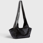 Model wearing the RACHEL COMEY Tool Bag in black leather, styled look.