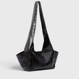 Model wearing the RACHEL COMEY Tool Bag in black leather, styled look.