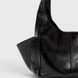 Model carrying the RACHEL COMEY Tool Bag in black leather across the body.