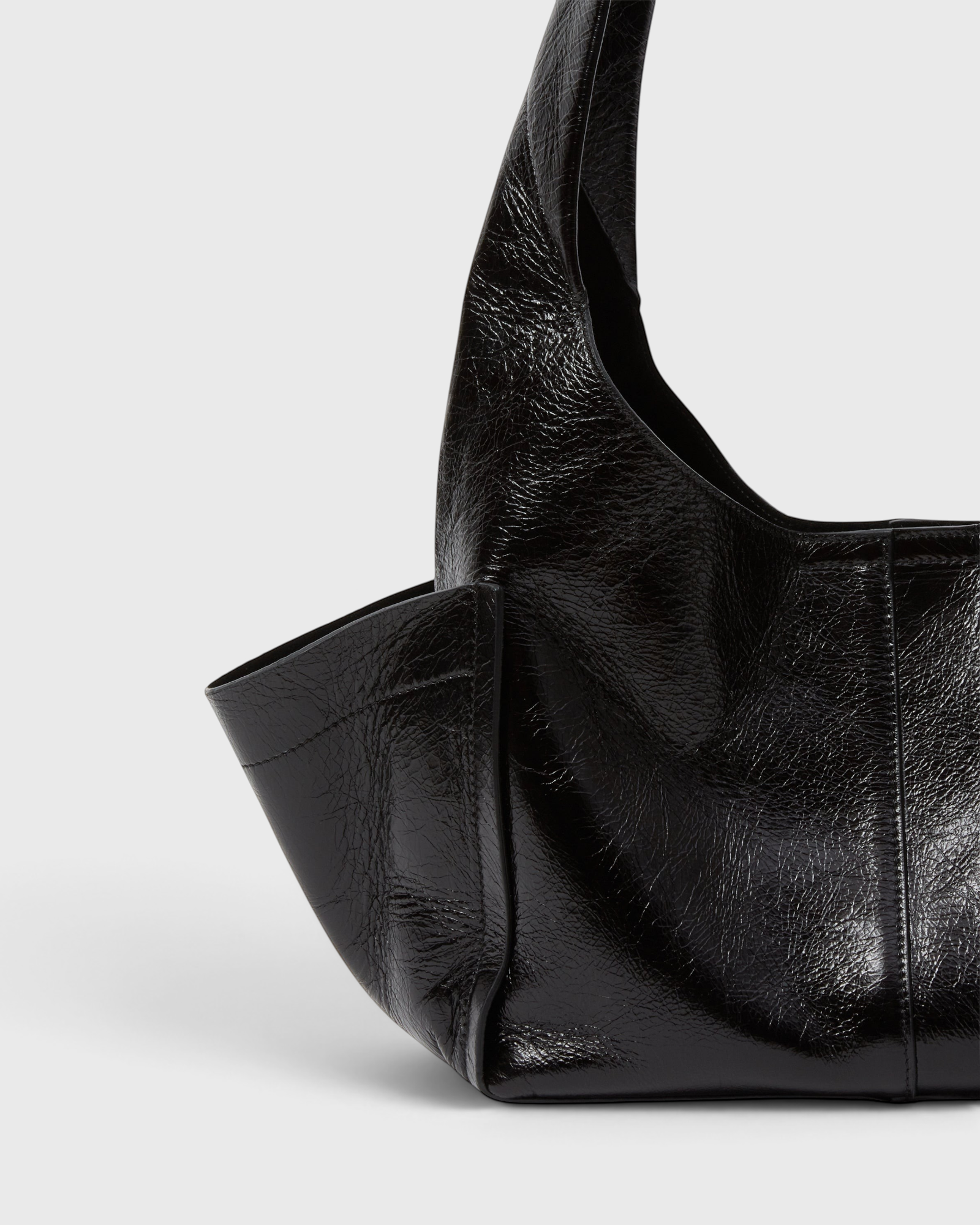 Model carrying the RACHEL COMEY Tool Bag in black leather across the body.