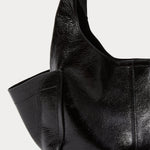 Model carrying the RACHEL COMEY Tool Bag in black leather across the body.
