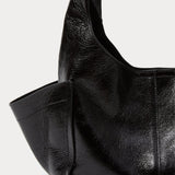 Model carrying the RACHEL COMEY Tool Bag in black leather across the body.