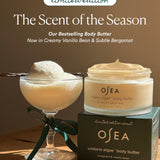 OSEA Undaria Algae Body Butter in Bergamot & Vanilla Bean, open jar on its limited edition box