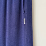 Blue fabric with a small white label on a beige background