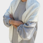 JONES + CO pearl white mohair pointelle shawl with delicate scalloped edges draped over a grey sweatshirt
