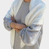 JONES + CO pearl white mohair pointelle shawl with delicate scalloped edges draped over a grey sweatshirt