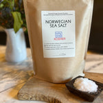 Norwegian Sea Salt package with a small dish of salt on a wooden board.