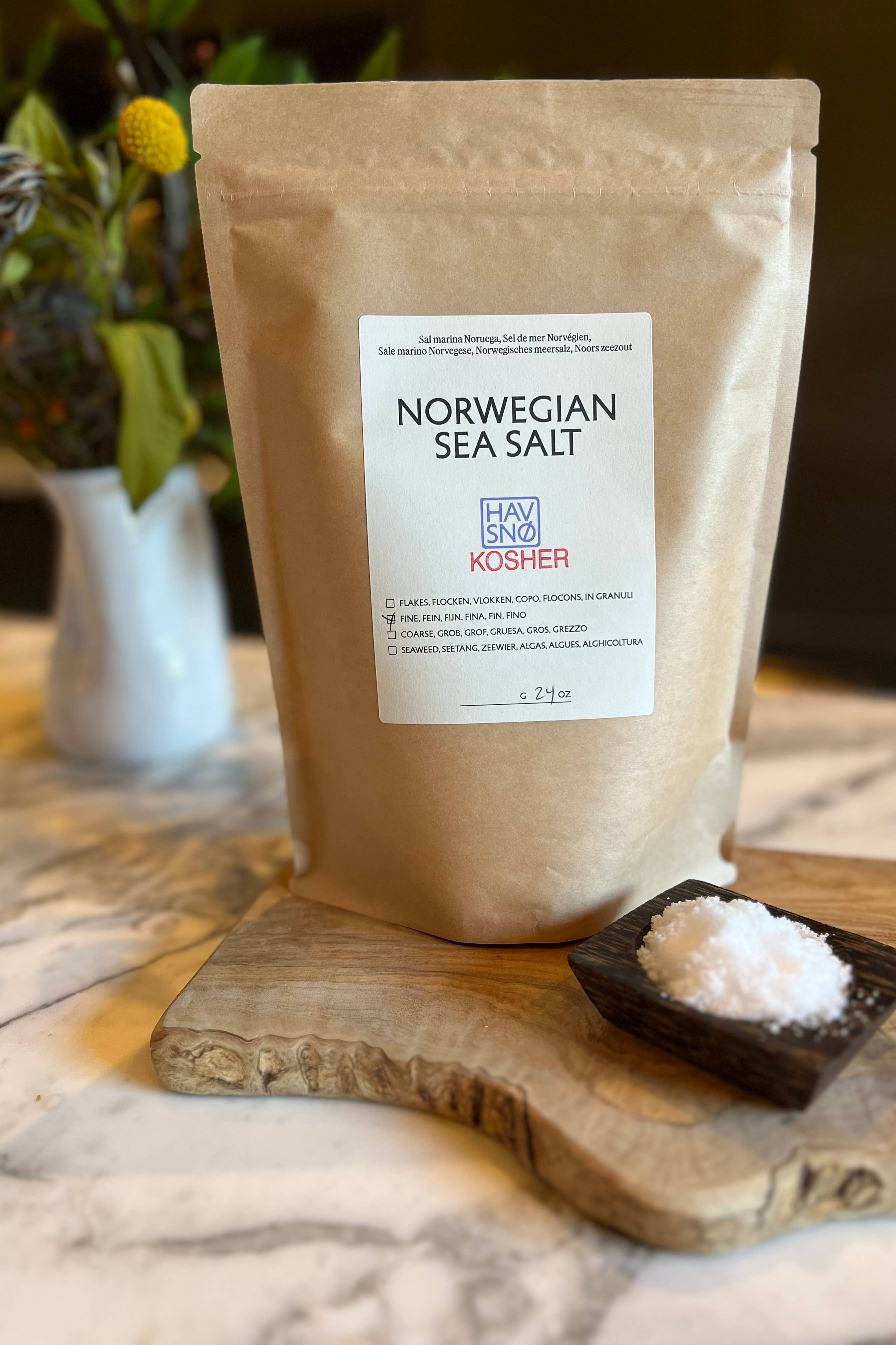 Norwegian Sea Salt package with a small dish of salt on a wooden board.