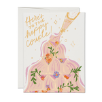 Greeting card with champagne bottle illustration and 'Here's to the happy couple' text on a white background