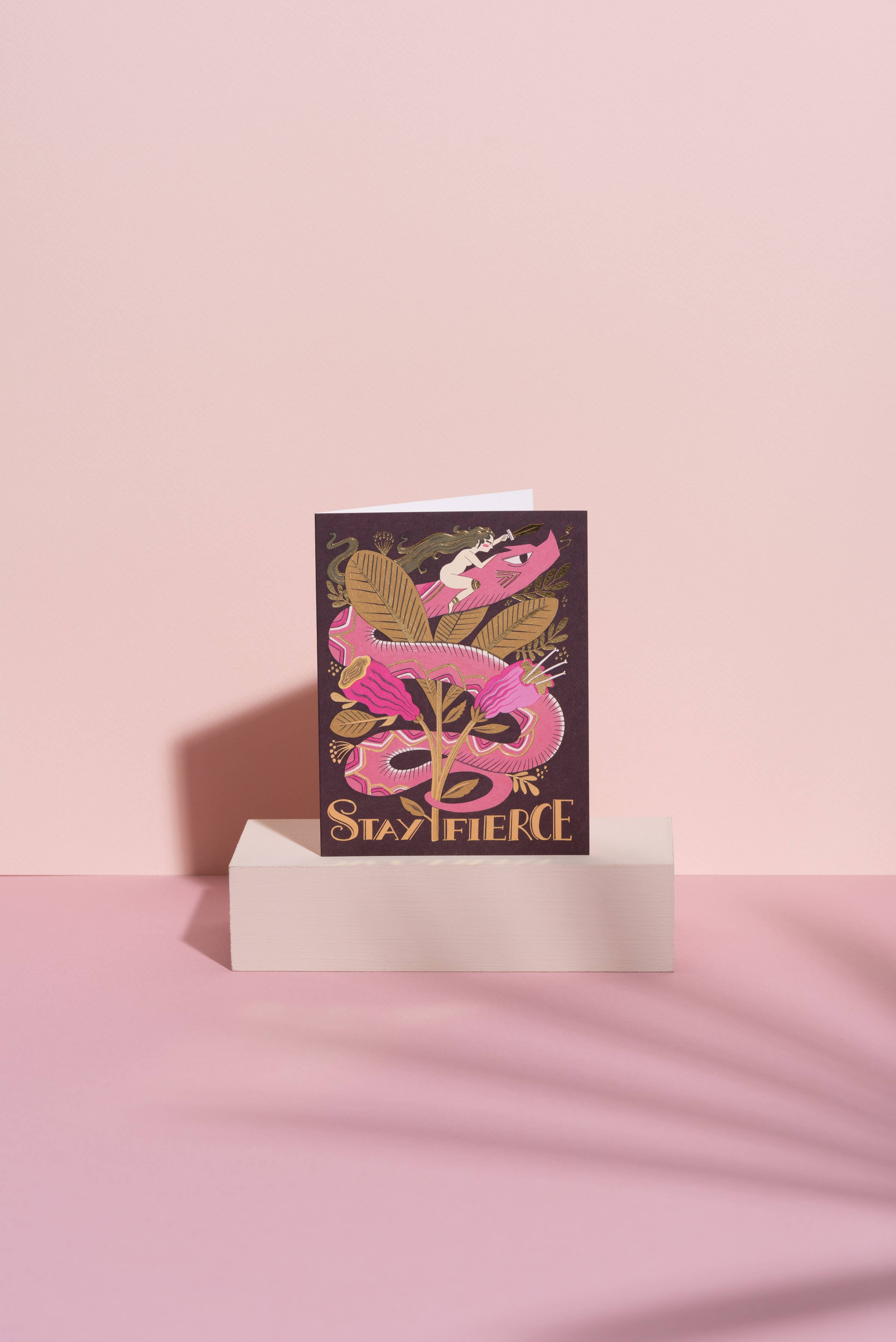 Greeting card with pink dragon design and 'Stay Fierce' text on a pink background