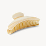 Beige hair clip on a white background