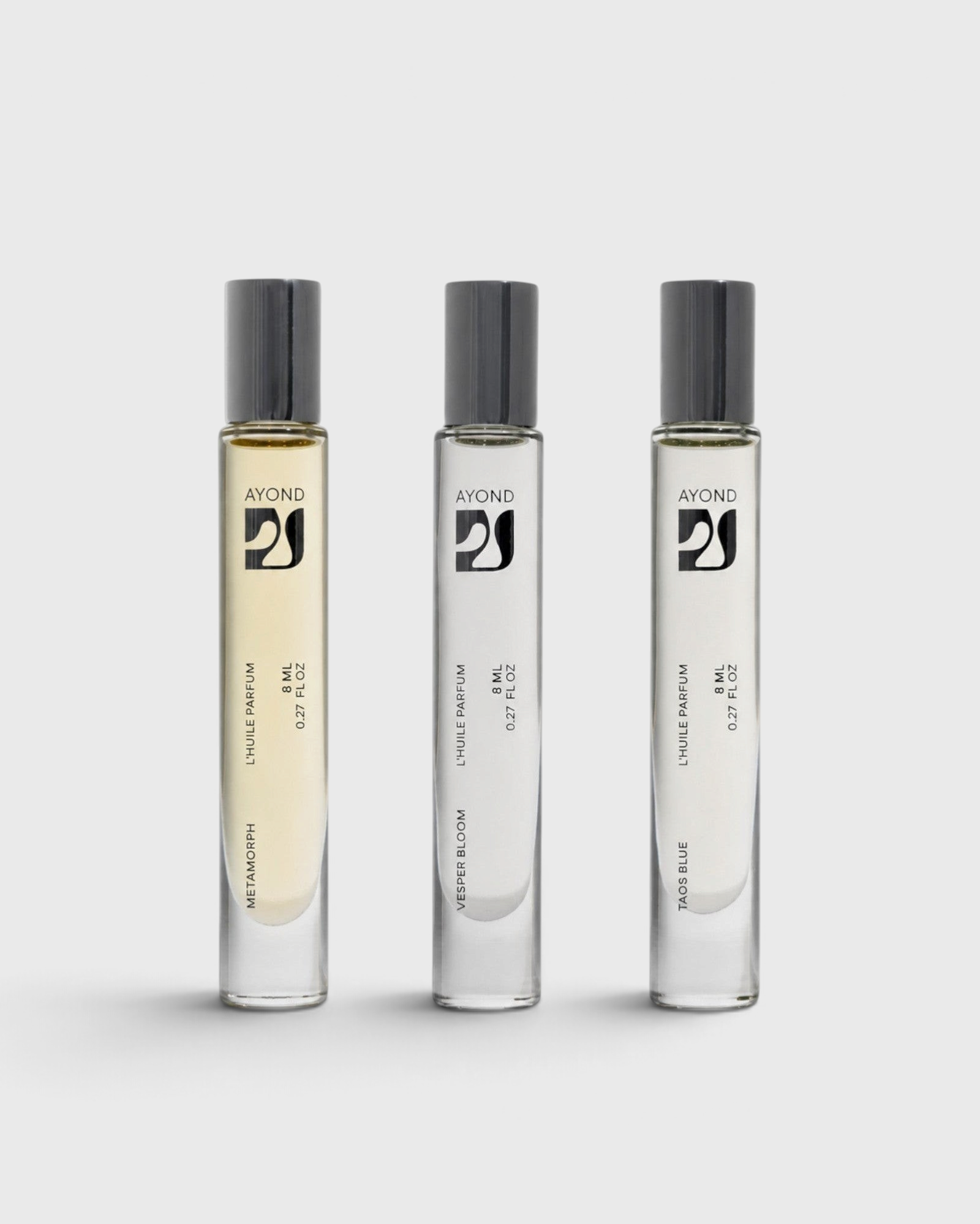 JONES + CO natural perfume oil rollers in three distinct scents with glass bottles and black caps.