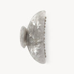 Grey shell style claw clip on a white background. 
