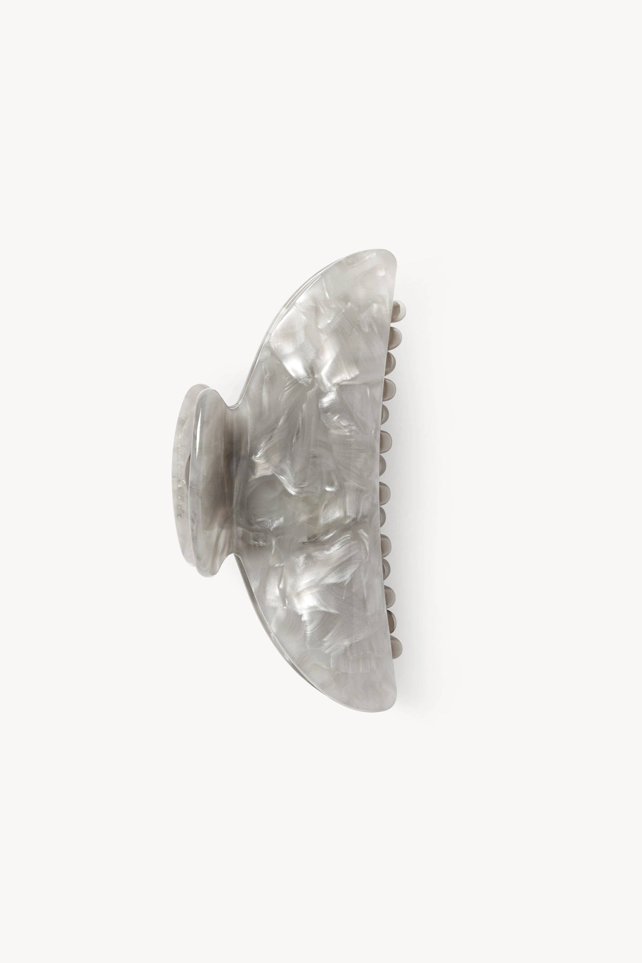 Grey shell style claw clip on a white background. 