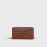 JONES + CO Luca wallet in sienna brown handwoven leather with a secure wrap-around zipper closure.