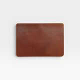 Brown leather laptop sleeve on a white background