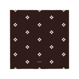 Brown square with white and red geometric pattern on a white background