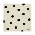 Beige fabric with black polka dot pattern on a white background