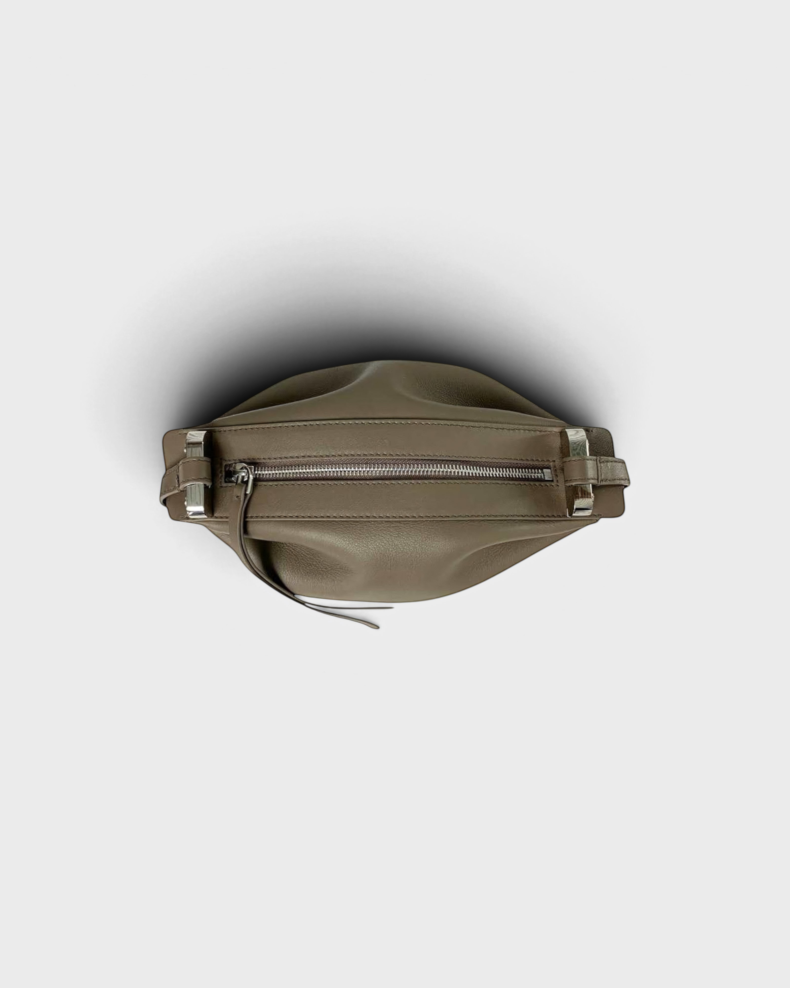 JONES + CO Bon-Bon taupe leather handbag featuring a pleated design and silver metal clasp detail from a top view.