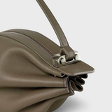 JONES + CO Bon-Bon taupe leather handbag featuring a pleated design and a polished silver metal clasp detail.