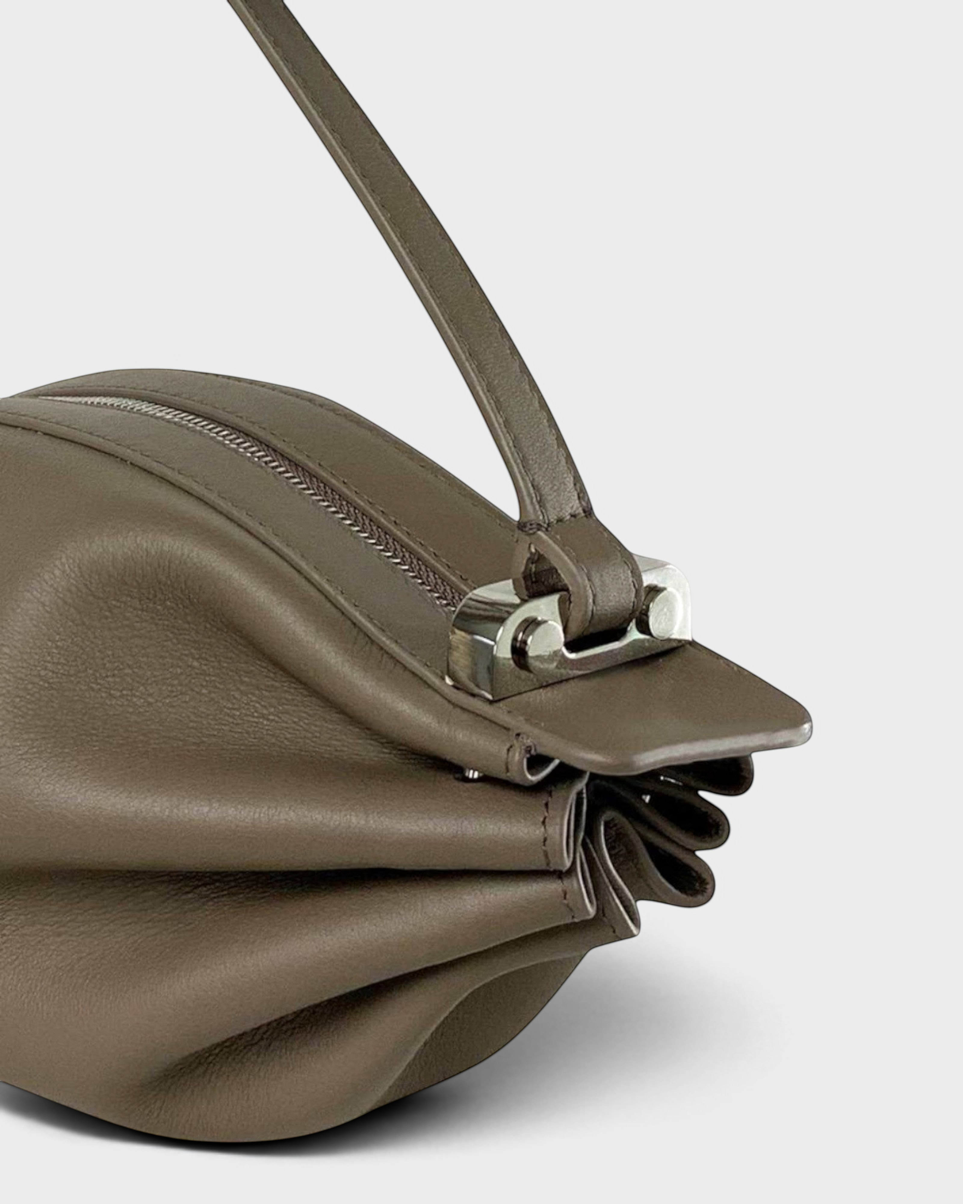 JONES + CO Bon-Bon taupe leather handbag featuring a pleated design and a polished silver metal clasp detail.