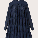 Merlette Soliman Dress in Navy — flat product shot of the tiered cotton voile dress with tonal floral embroidery, long sleeves and round neck