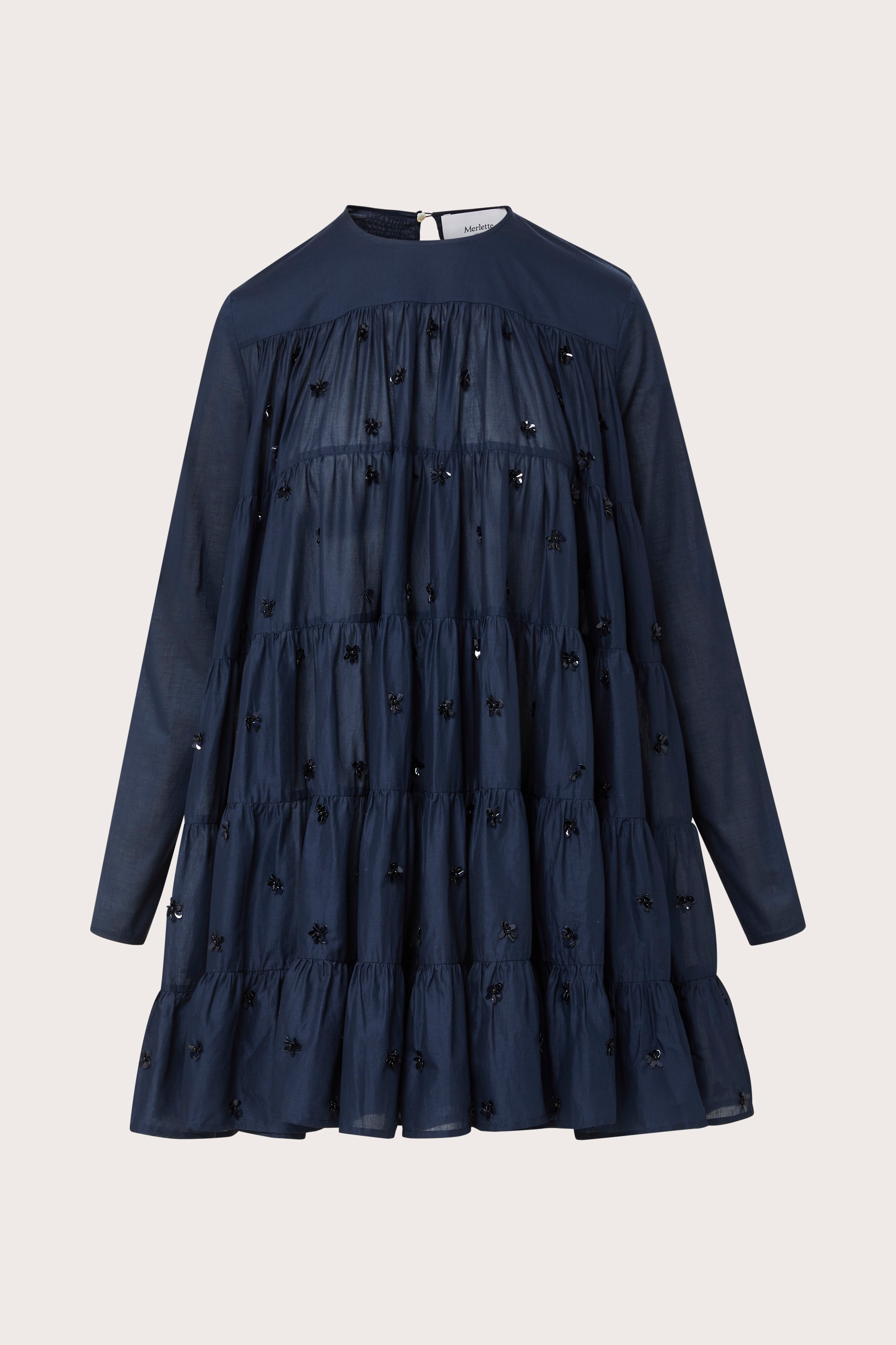 Merlette Soliman Dress in Navy — flat product shot of the tiered cotton voile dress with tonal floral embroidery, long sleeves and round neck