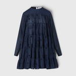 Merlette Soliman Dress in Navy — flat product shot of the tiered cotton voile dress with tonal floral embroidery, long sleeves and round neck