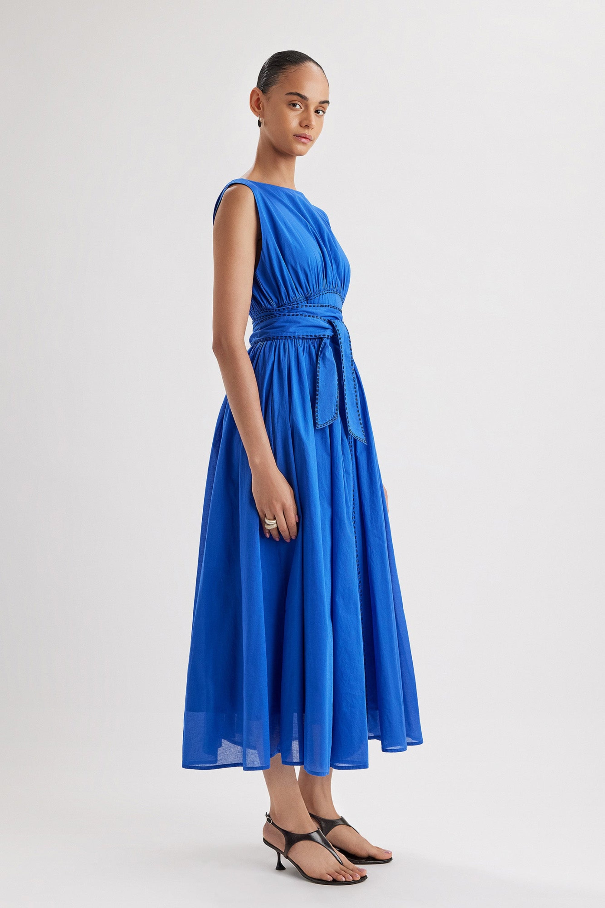 Merlette Verena Dress in Ultramarine - three-quarter view showing the skirt volume and drape