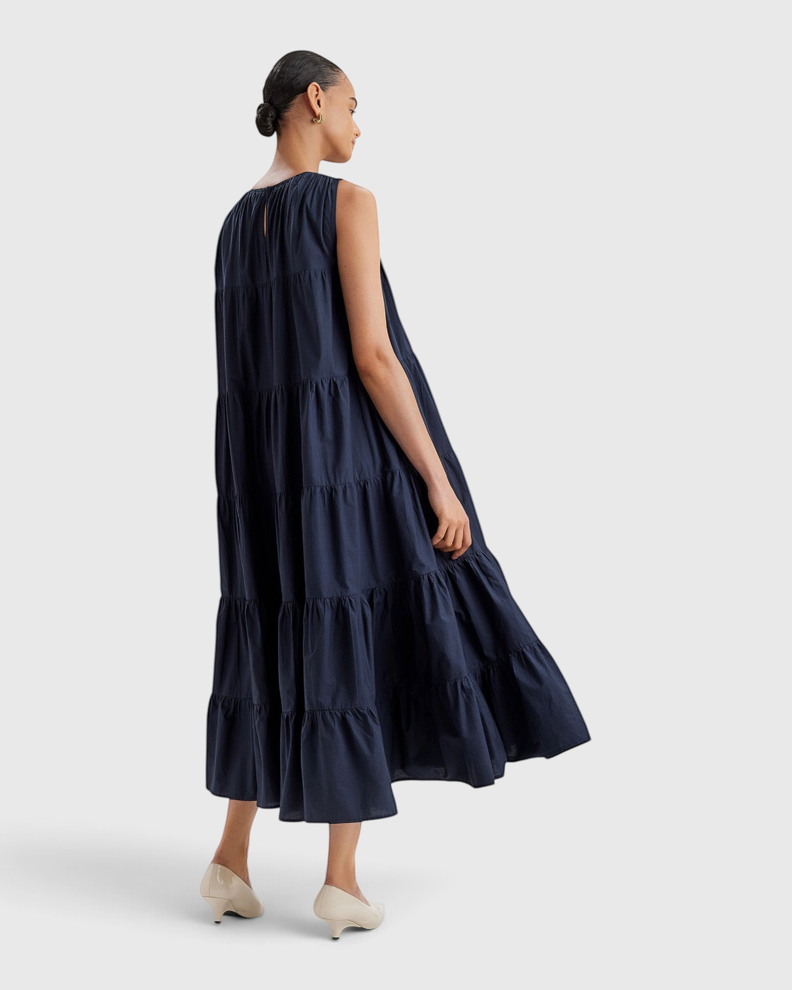 Merlette Caron Dress in Navy - three-quarter view showing the tiered skirt in movement
