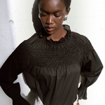 Merlette Majorelle Top in Black - campaign image showing the ruffled collar and smocking