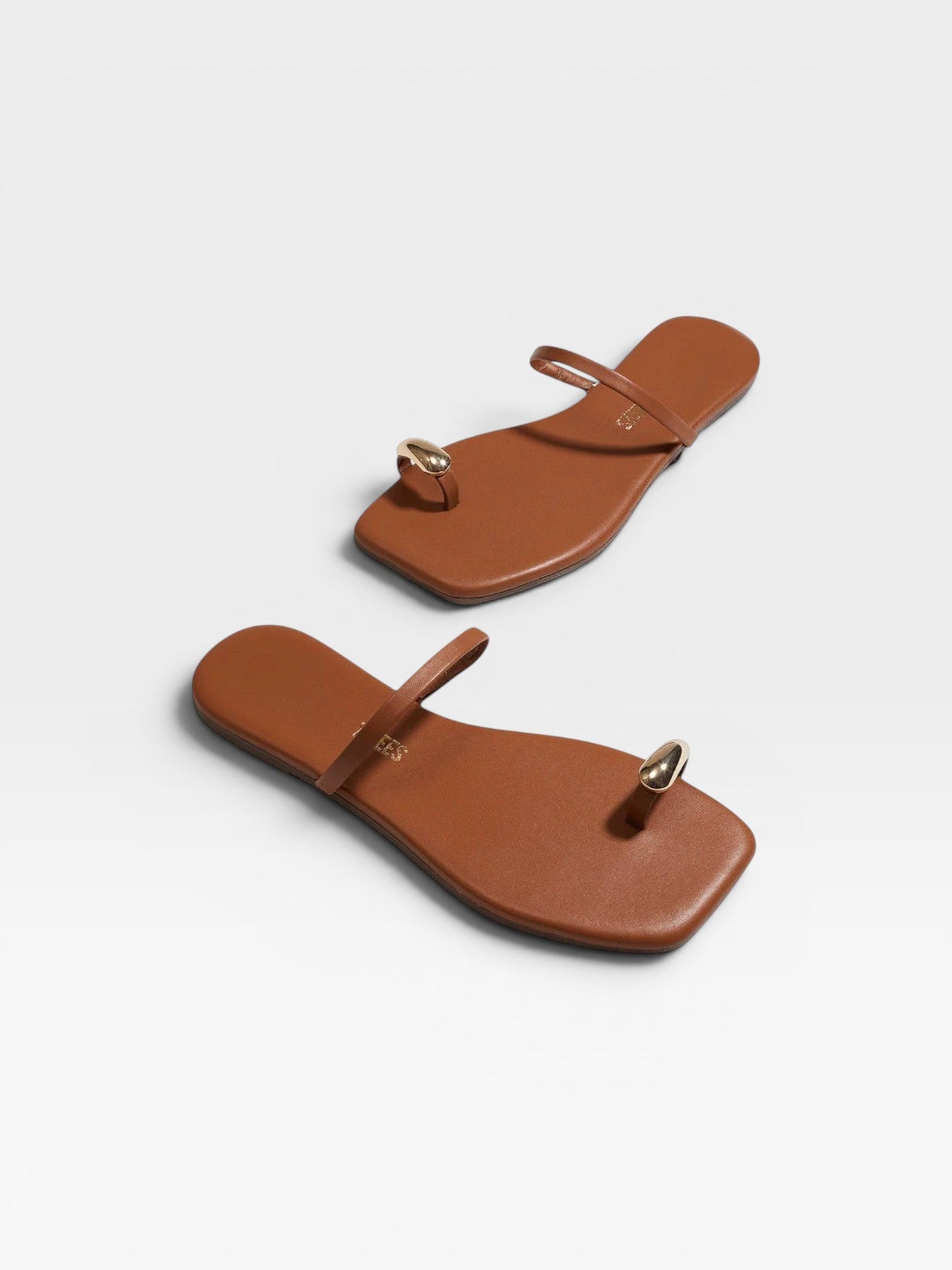JONES + CO Colette Sandal in Au Naturale brown leather with gold toe ring detail. Minimalist slip-on sandal.