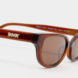 close up logo view of Romi Sunglasses - Transparent Rust