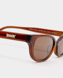 close up logo view of Romi Sunglasses - Transparent Rust