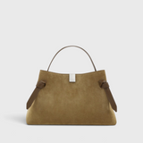 JONES + CO Gyoza pouch in fennel suede with a soft texture, structured handle, and elegant knot side details.