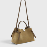 JONES + CO Gyoza pouch in fennel suede with brown leather handles and a compact, elegant design.