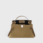 JONES + CO Gyoza pouch in fennel suede with a structured handle and elegant knot details on a neutral background