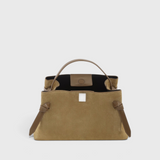 JONES + CO Gyoza pouch in fennel suede with a structured handle and elegant knot details on a neutral background