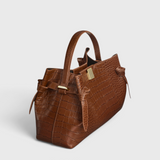 JONES + CO Gyoza pouch in brown Sierra embossed leather with a crocodile texture and gold hardware side view