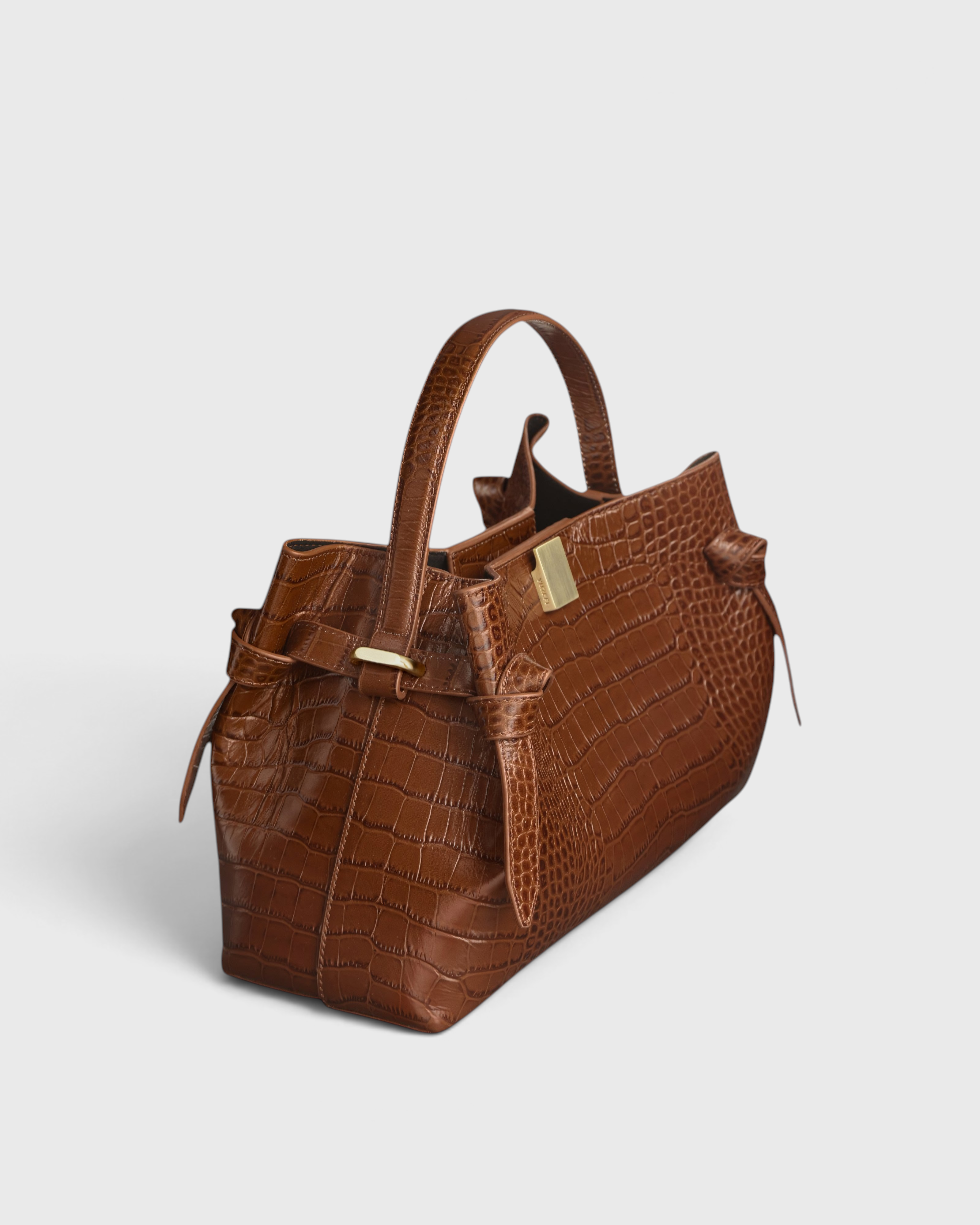 JONES + CO Gyoza pouch in brown Sierra embossed leather with a crocodile texture and gold hardware side view