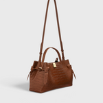 JONES + CO Gyoza pouch in brown Sierra embossed leather with a structured silhouette and gold hardware detail.
