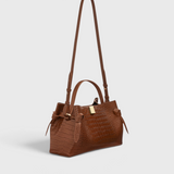JONES + CO Gyoza pouch in brown Sierra embossed leather with a structured silhouette and gold hardware detail.