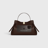 JONES + CO Gyoza Sierra embossed brown leather pouch with gold hardware, shown with an iPhone 16 Pro Max for scale.