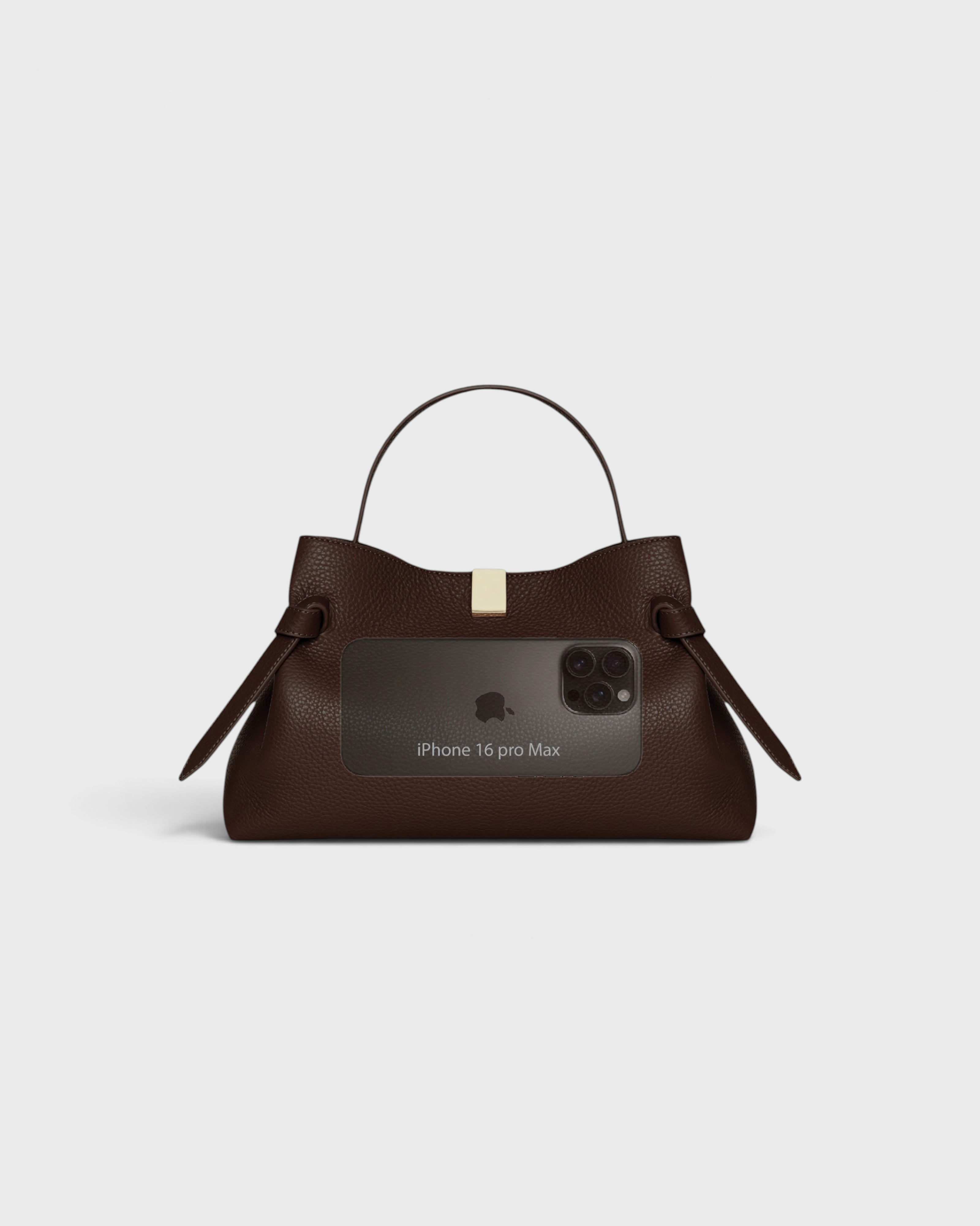 JONES + CO Gyoza Sierra embossed brown leather pouch with gold hardware, shown with an iPhone 16 Pro Max for scale.