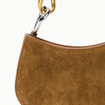 Detail of the two-tone gold and silver link hardware on the STAUD Ollie Bag in Cigar suede