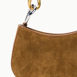 Detail of the two-tone gold and silver link hardware on the STAUD Ollie Bag in Cigar suede