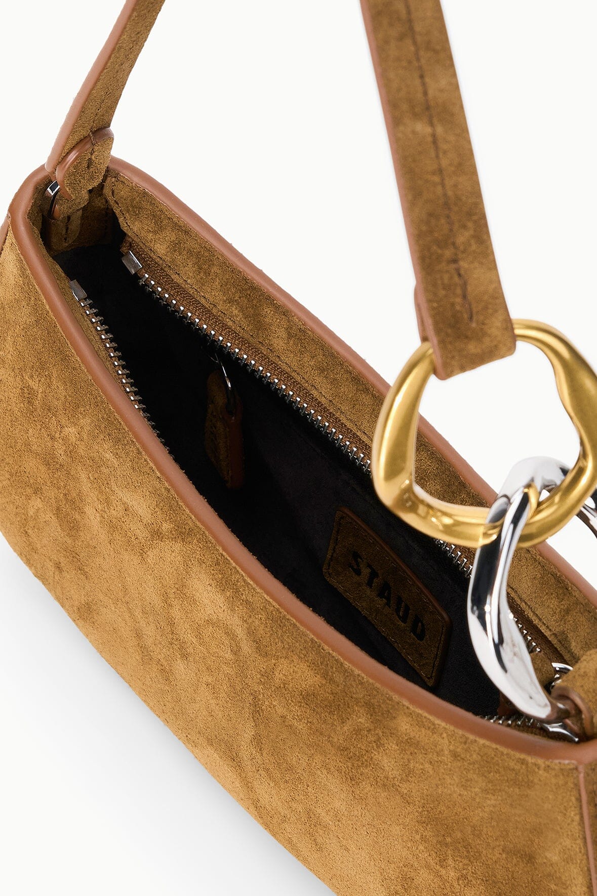 Interior of the STAUD Ollie Bag in Cigar showing the zip pocket and STAUD label