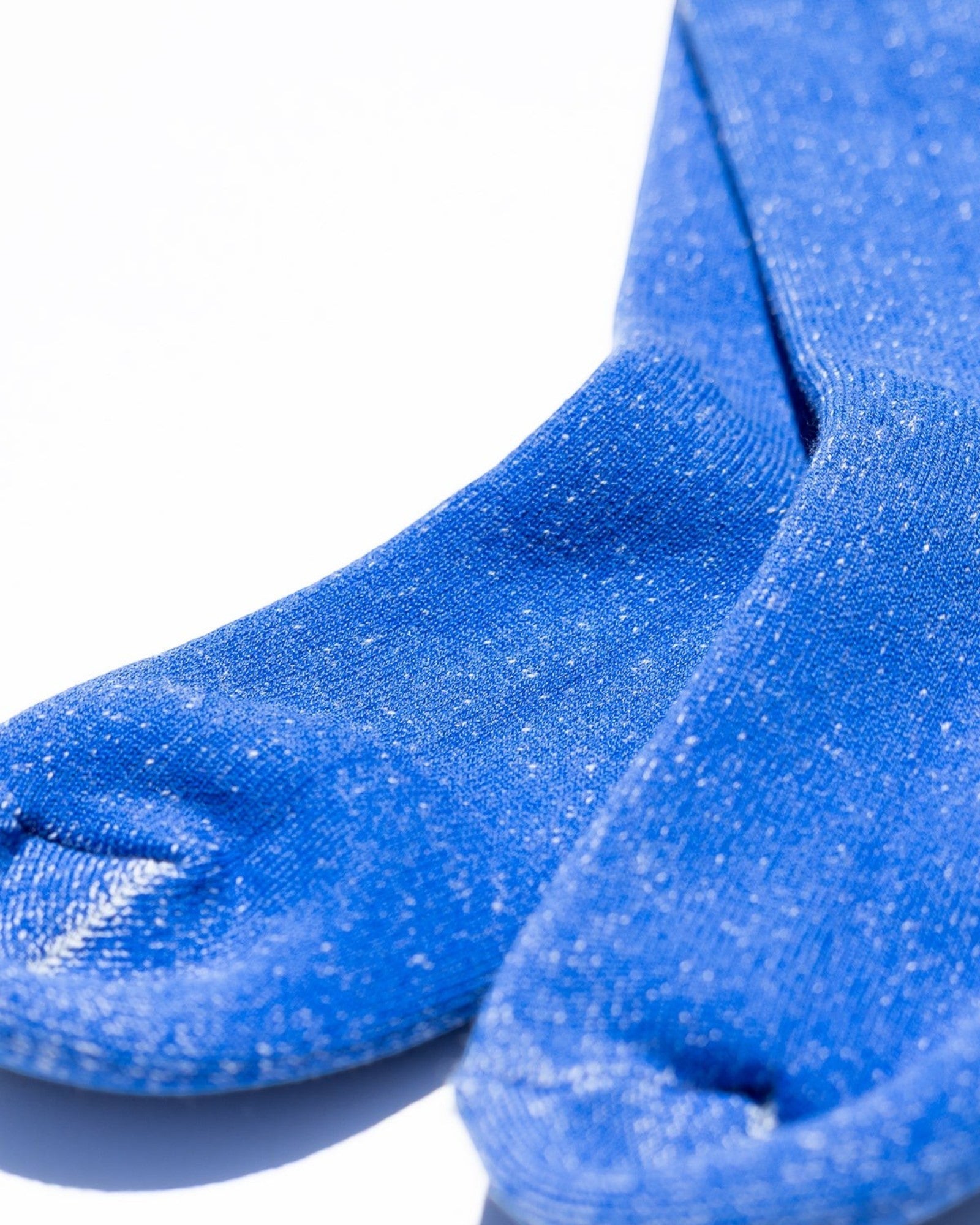 Blue socks with a textured finish on a white background