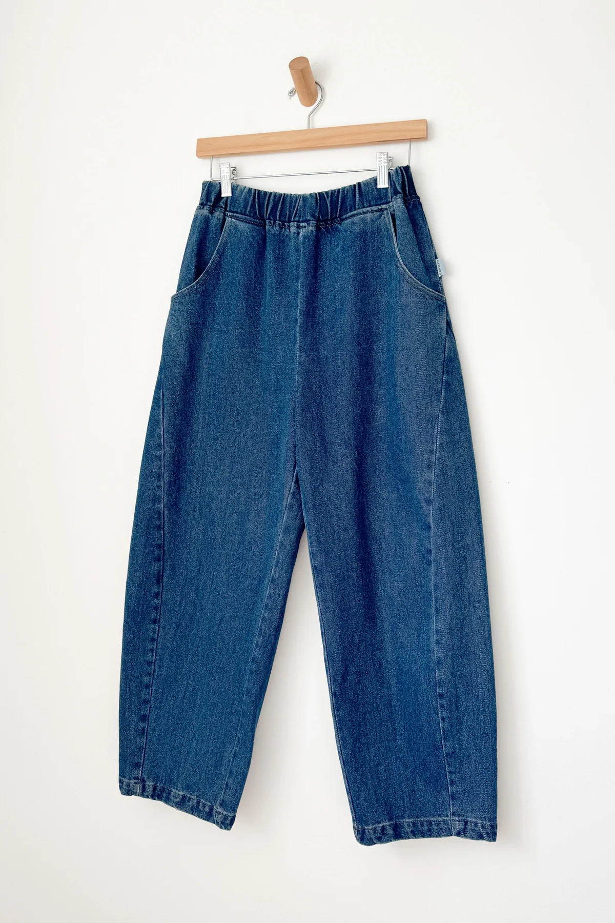 Arc Pants - Blue Denim hanging on hanger