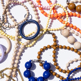 Colorful beaded bracelets and necklaces on a white background